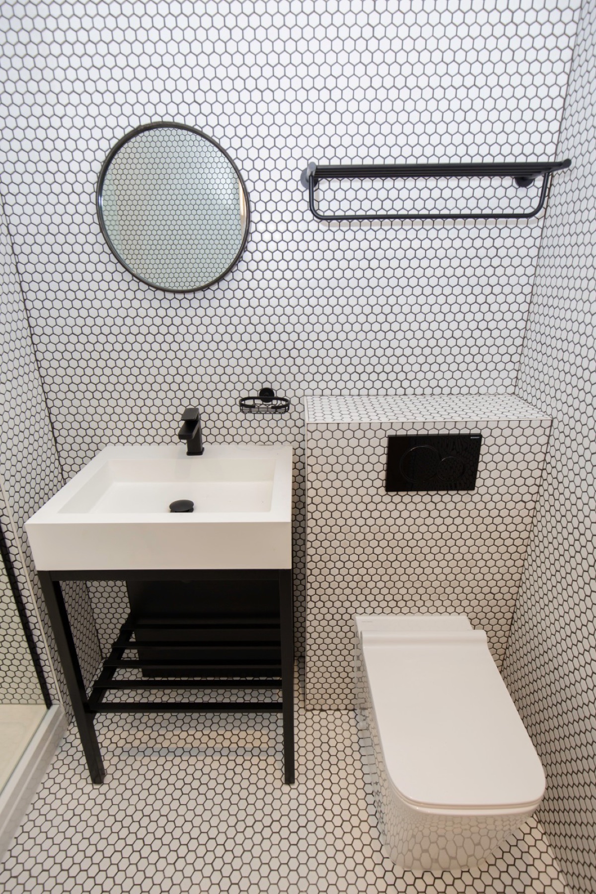 The finished bathroom fully tiled in penny-round mosaic